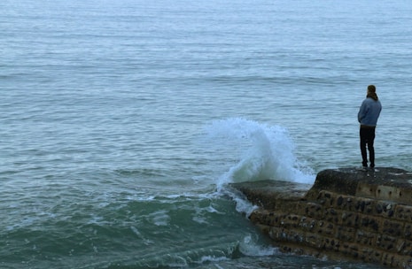 brown rock formation on sea during daytime