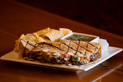 A colorful plate of veggie-packed quesadillas cut into kid-friendly triangles.