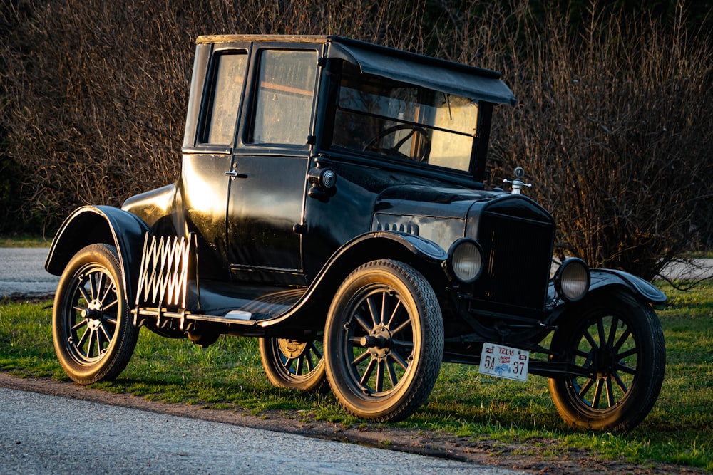 black vintage car on green grass field during daytime