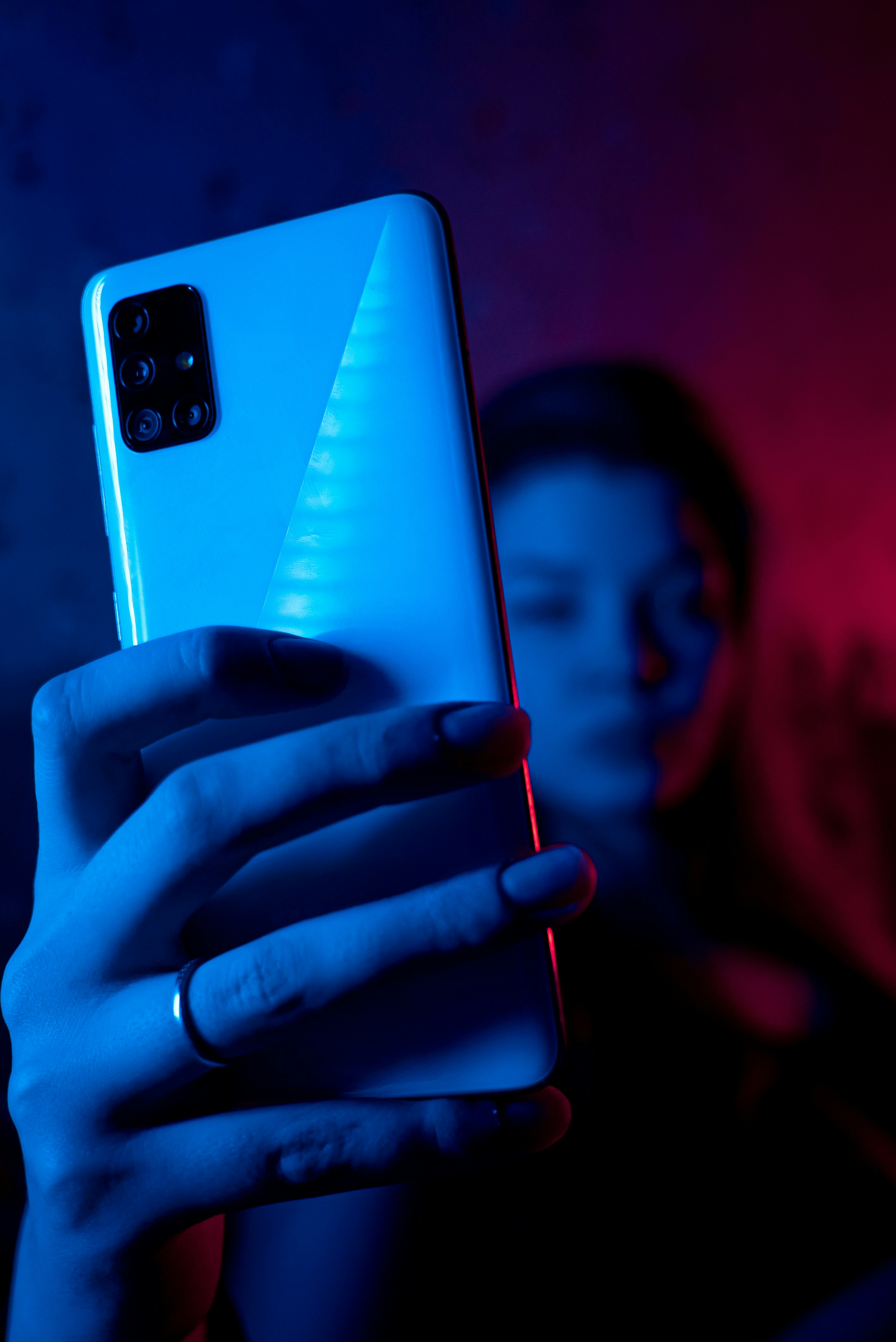 A girl holds smartphone