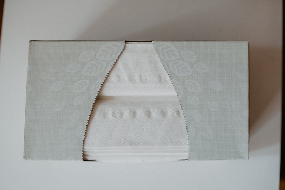 white floral textile on white table