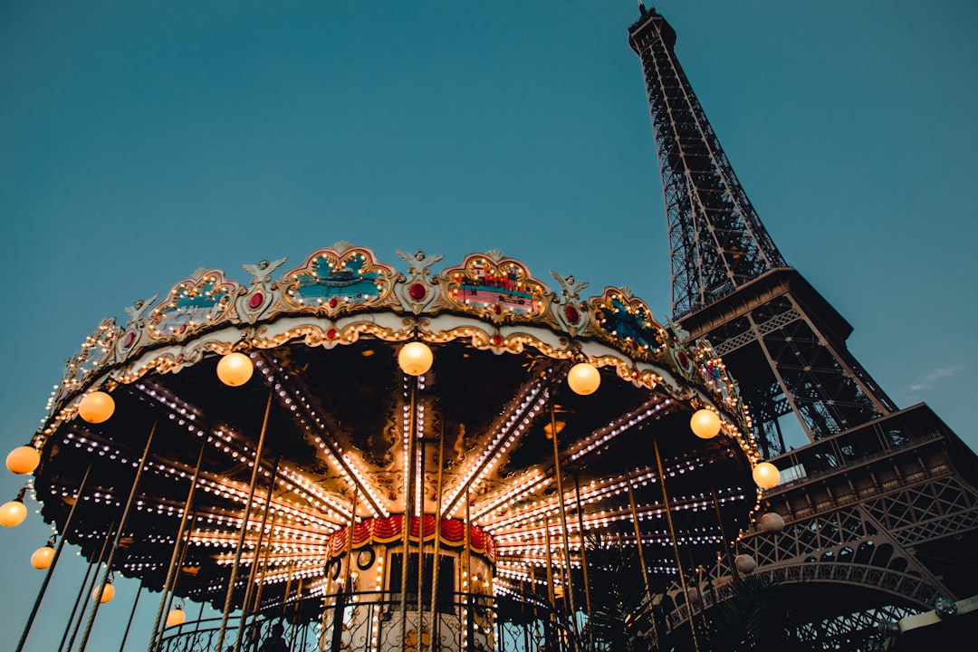 white and blue carousel with lights turned on during night time