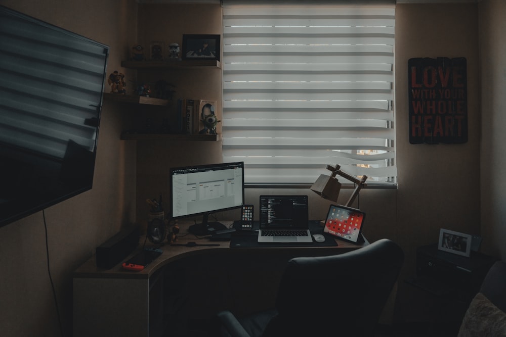 black flat screen computer monitor on brown wooden desk