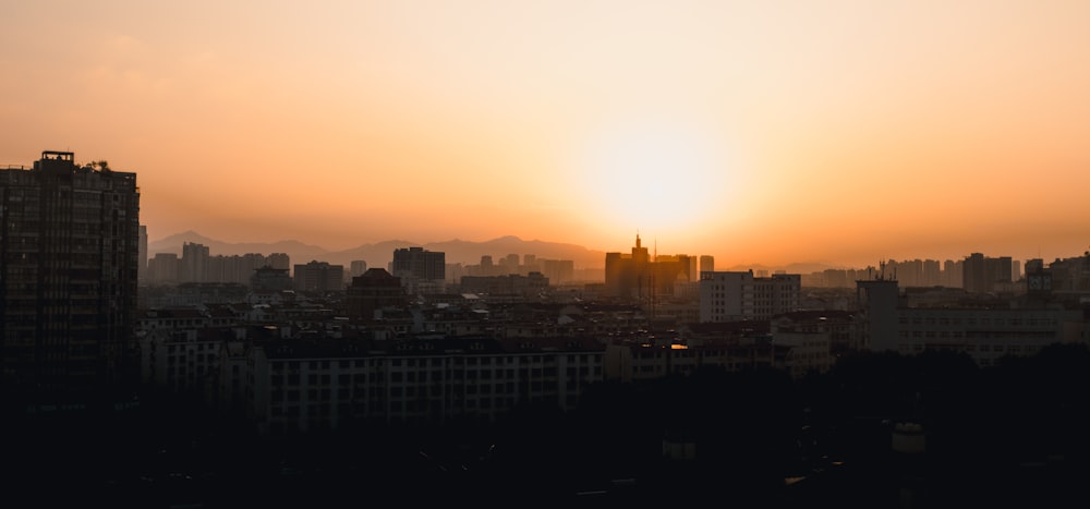 city skyline during sunset with orange sky