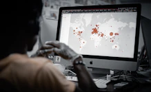 Image showing a professional planning delivery routes with a digital map on screen.
