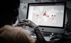 A team working with digital maps and global market data in a modern office.
