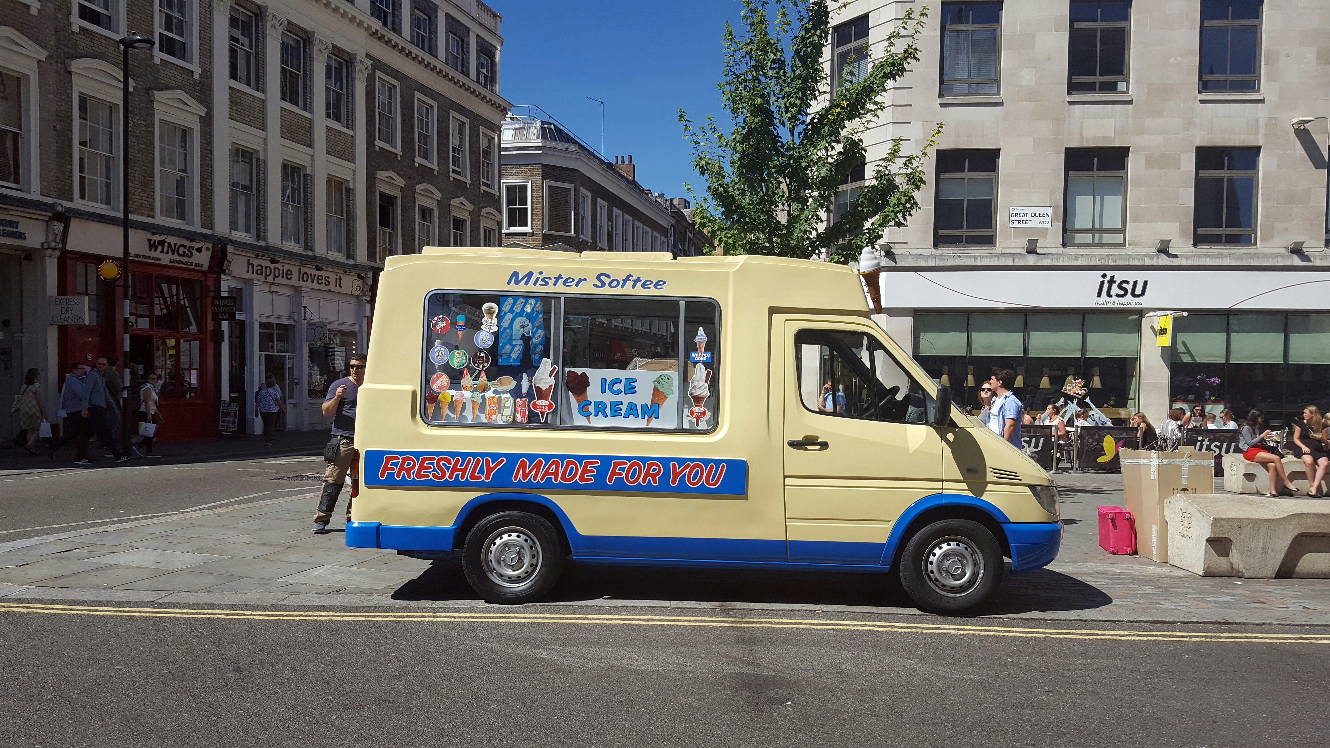 yellow and blue van on road during daytime