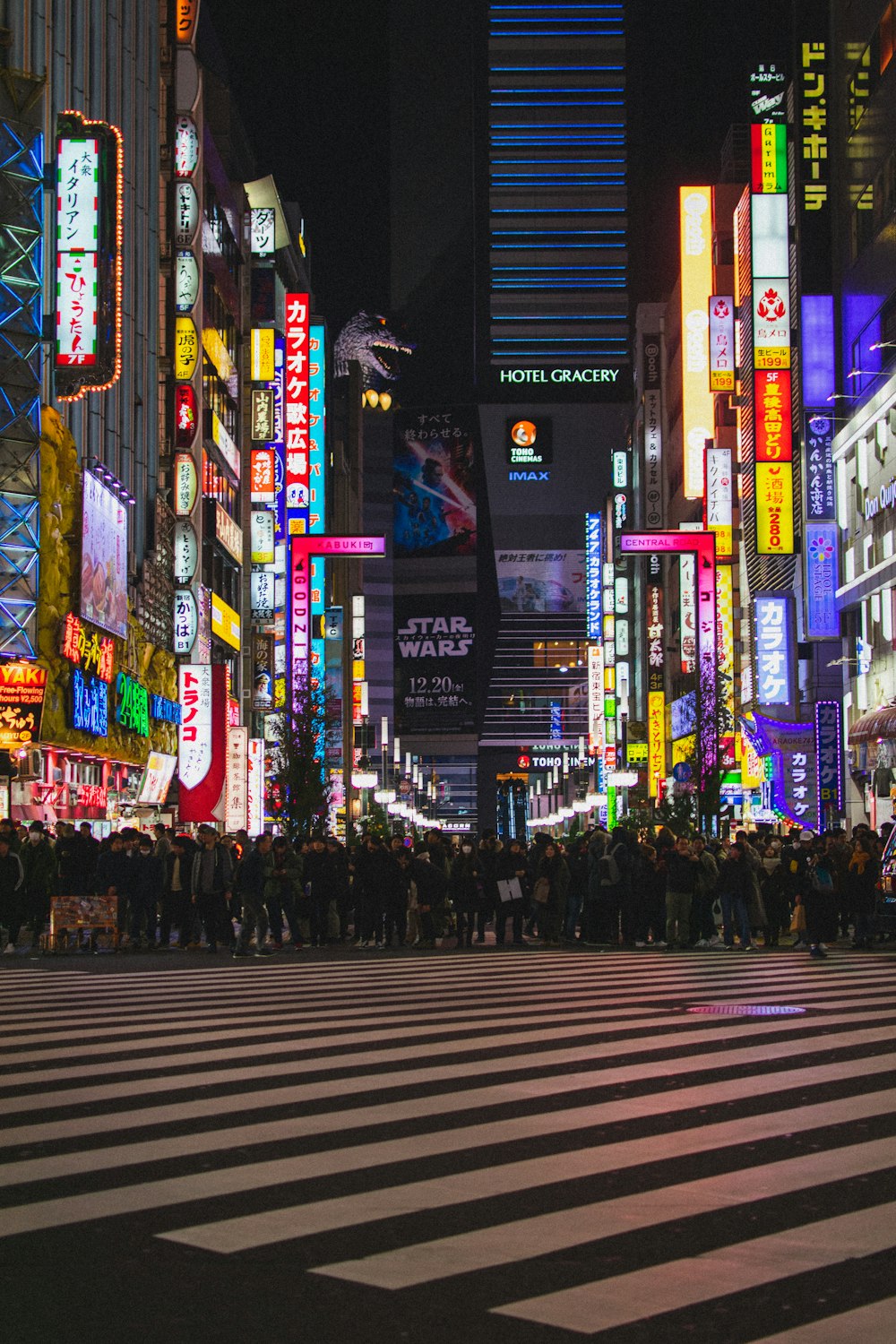 people walking on pedestrian lane during night time