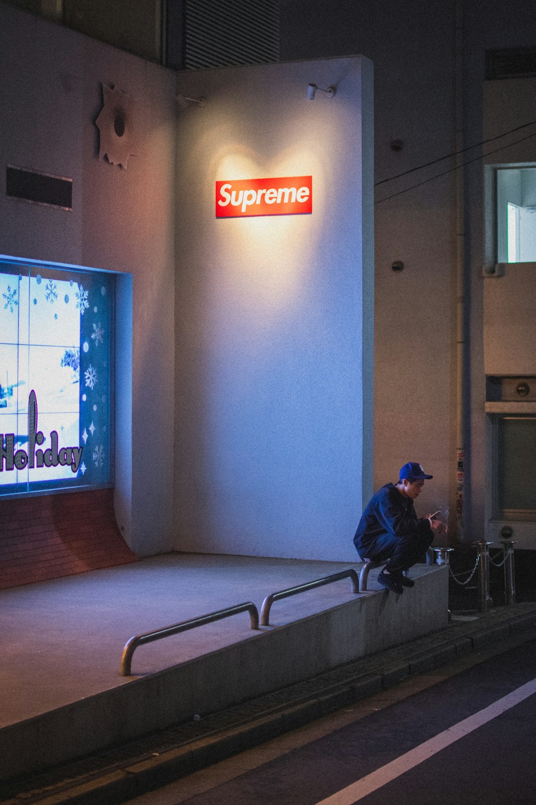 man in blue jacket sitting on black wheelchair