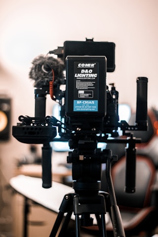 Professional camera and audio equipment setup in a studio environment.