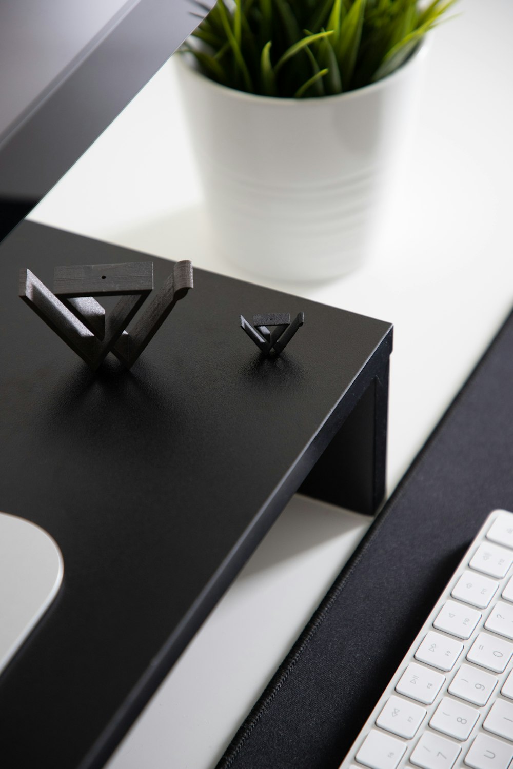 black wooden table with silver imac and apple keyboard