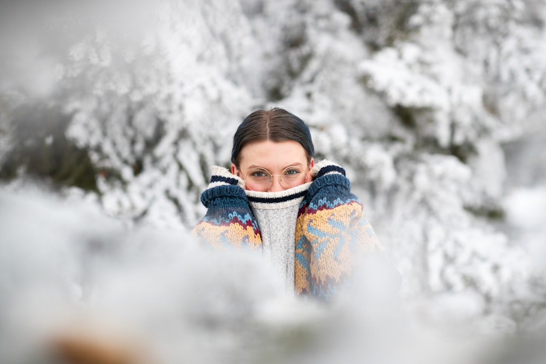 girl in blue and white jacket covered with snow