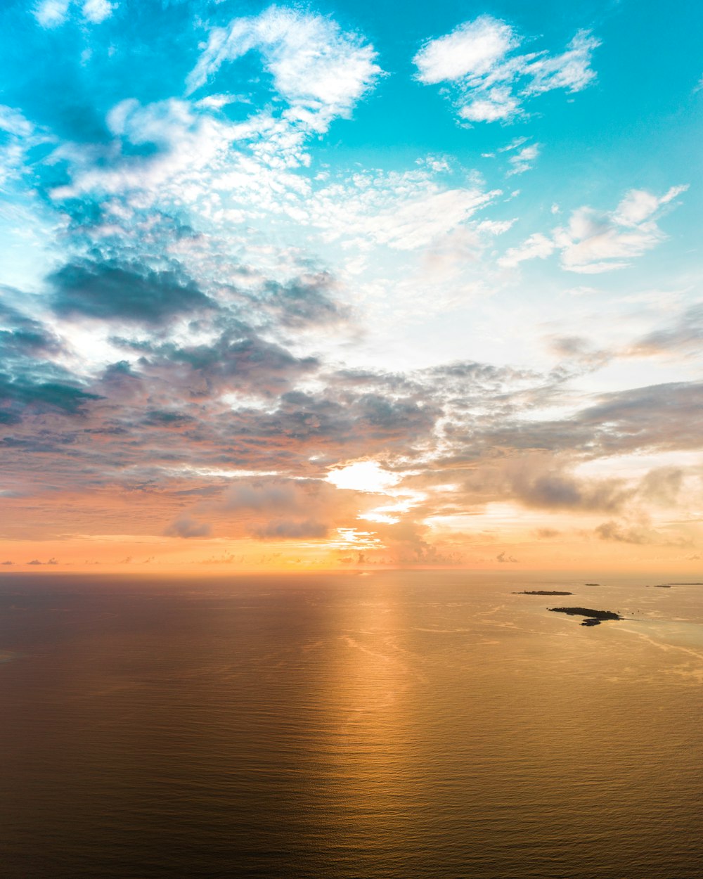 body of water under blue sky during sunset