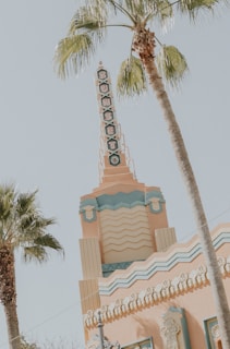 A colorful vintage travel poster highlighting Sarasota’s art deco architecture with sunset tones.