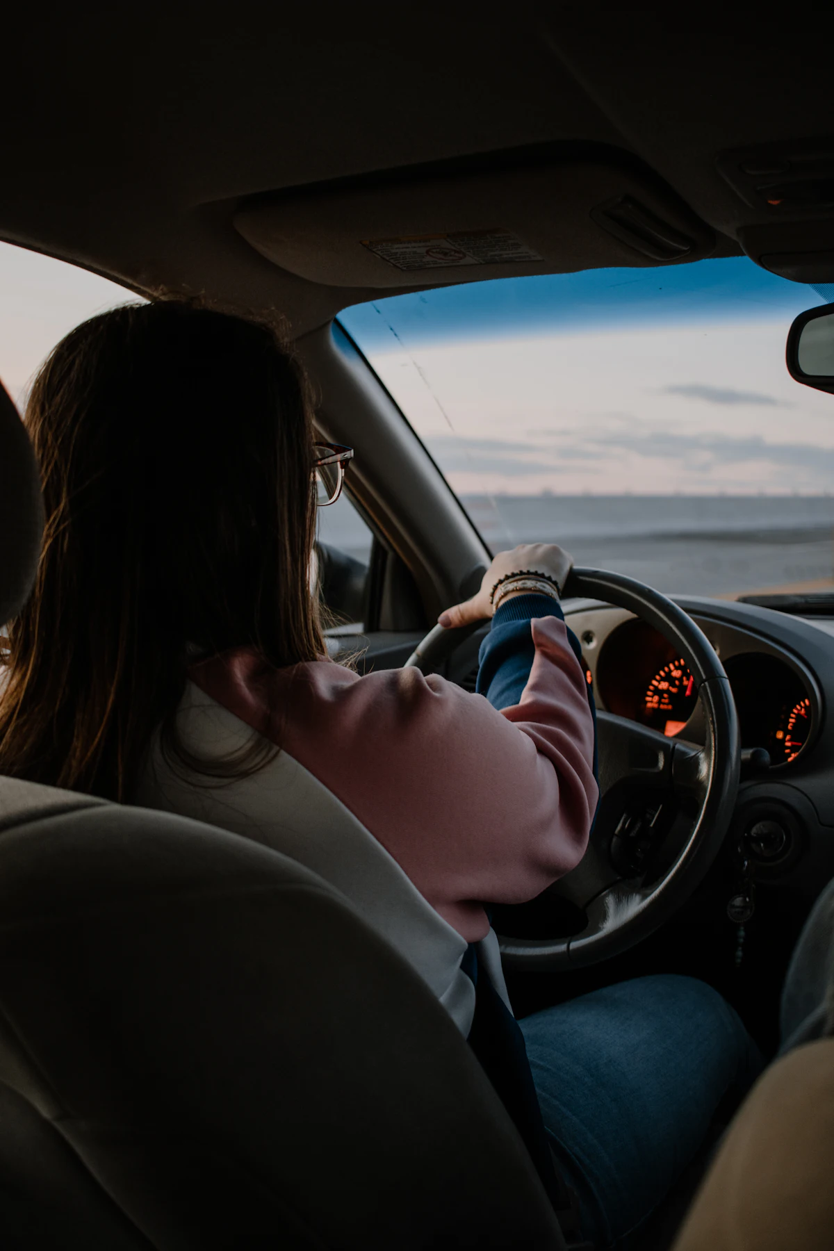 Student driving through a busy city intersection during a lesson