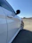Image of a shiny, spotless car parked outside with a clear blue sky in the background.