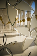 Close-up of delicate geometric Islamic ornaments with soft shadows on a white background.