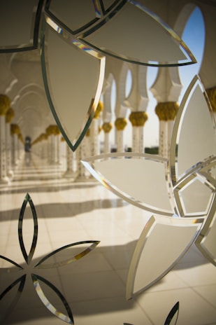 Close-up of delicate geometric Islamic ornaments with soft shadows on a white background.