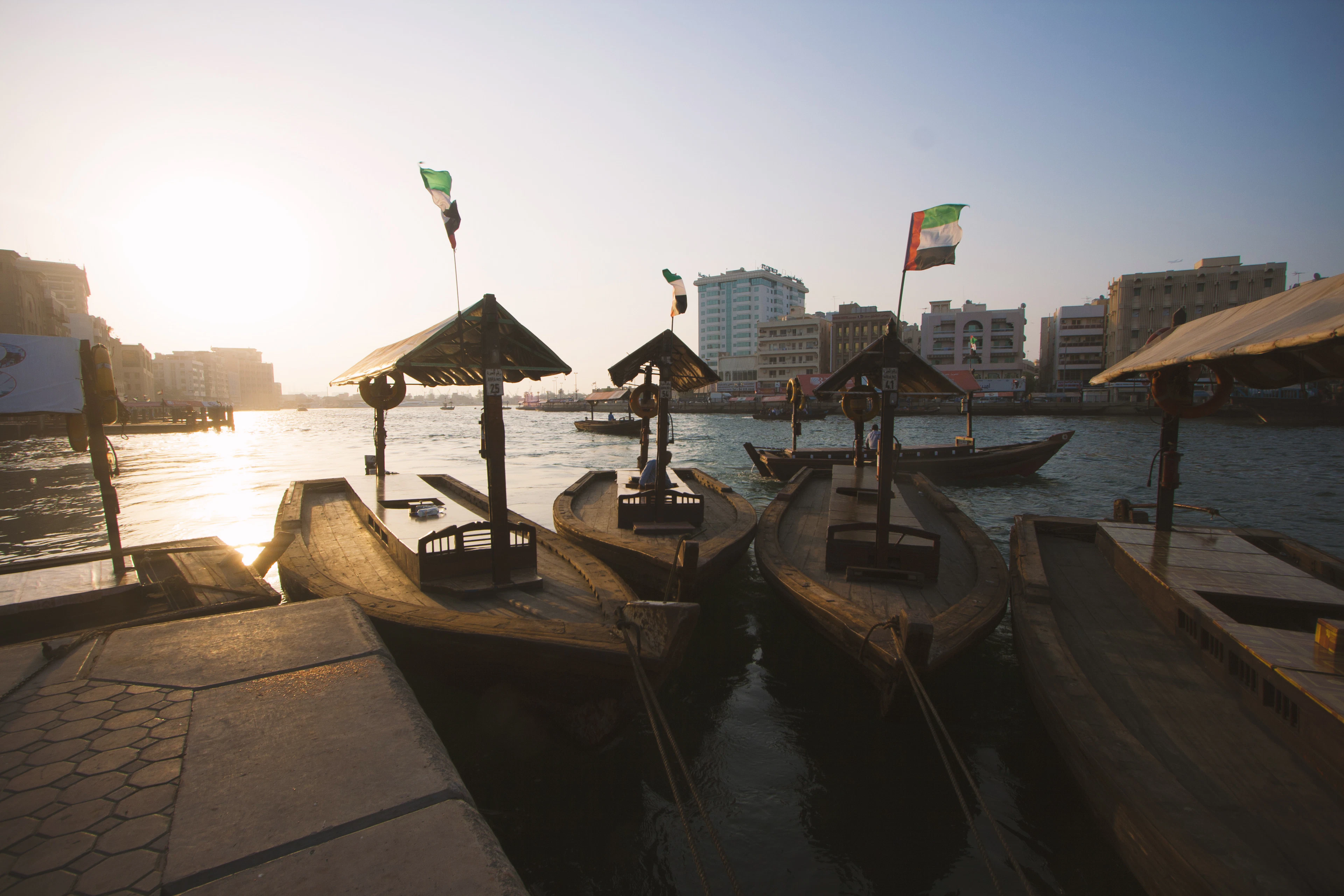 Abra boats at a wooden station on Dubai Creek