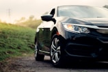 black mercedes benz c class on dirt road during daytime