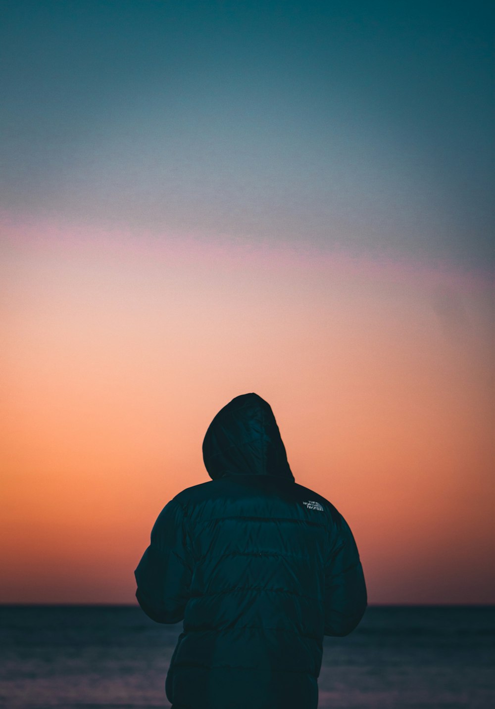 silhouette of person wearing hoodie