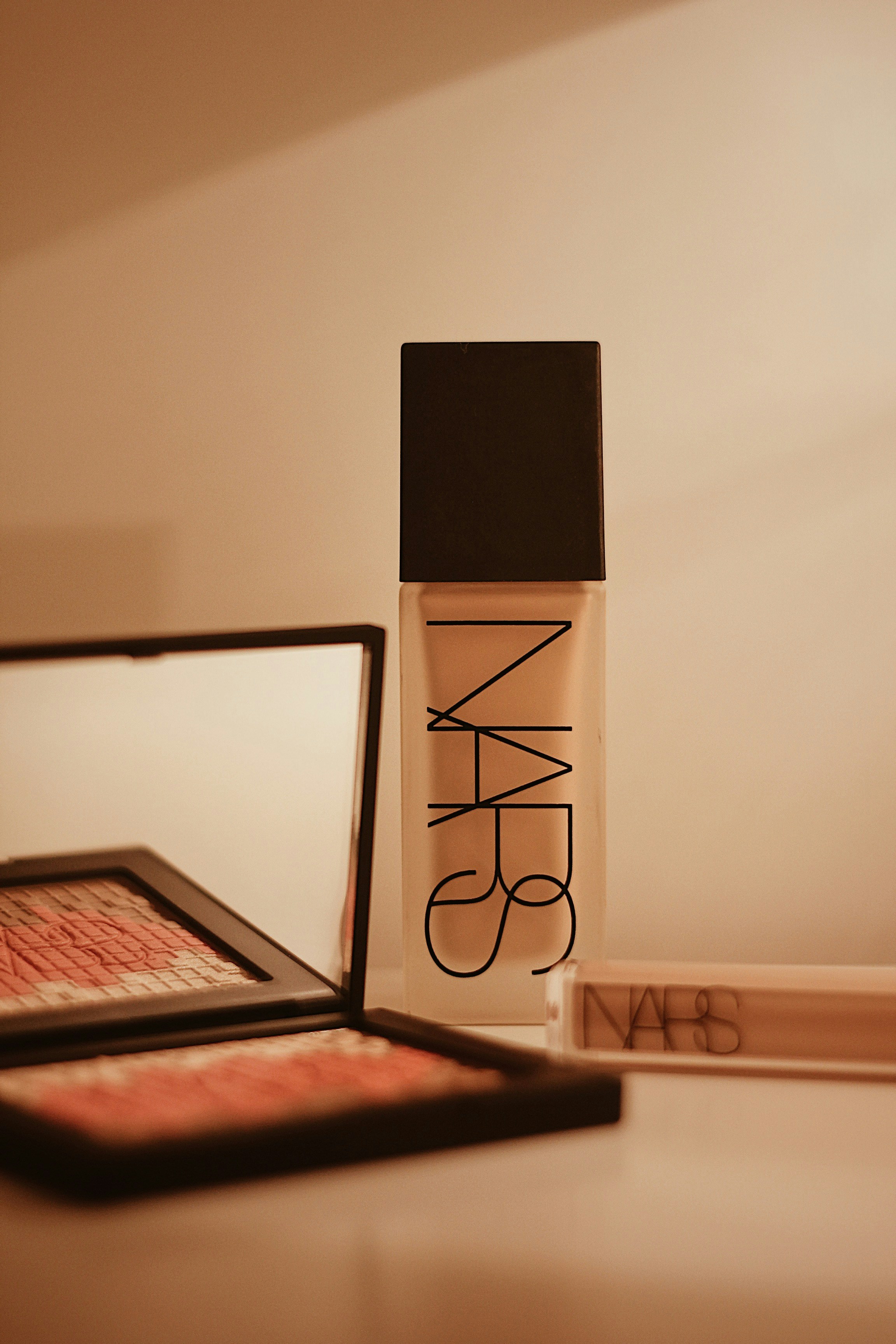 Foundation bottle with nude tones on bright clean background, natural beauty product photography