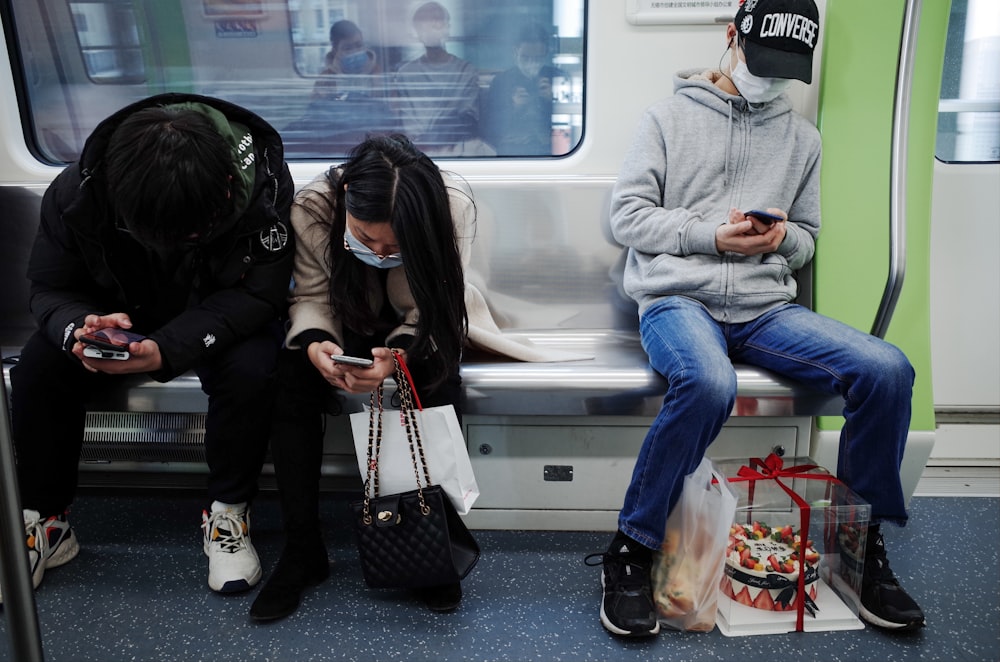 woman in gray sweater sitting beside woman in black leather jacket