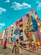 A colorful street scene in Algiers with murals of famous Algerians.