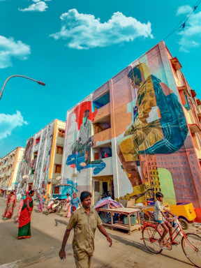 A vibrant street scene in a Rio favela with colorful murals and people wearing bold black and gold streetwear.