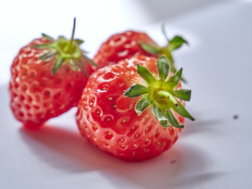 red strawberries on white surface