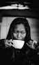 grayscale photo of woman holding ceramic mug