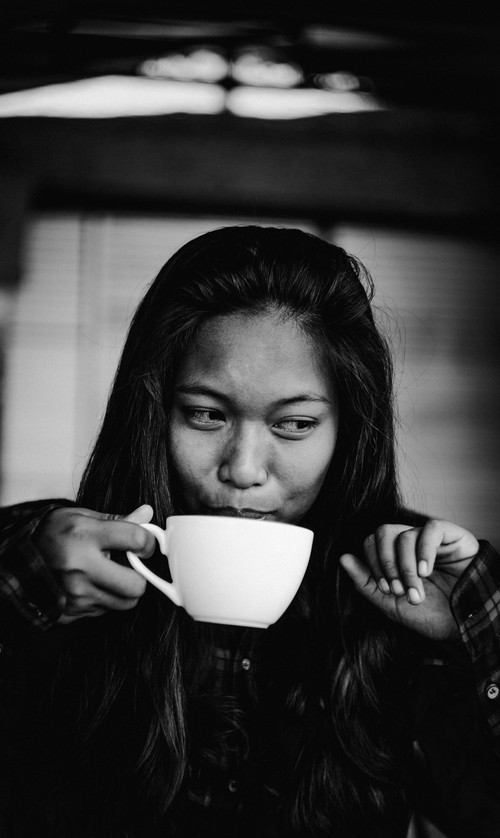 grayscale photo of woman holding ceramic mug