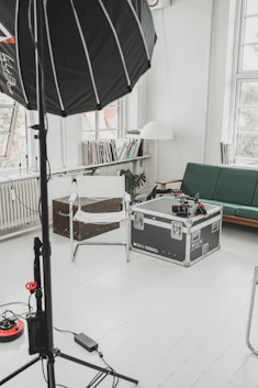 Wide shot of the spacious 140 sqm photography studio with natural light flooding through large hangar windows