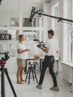 man and woman holding camera in front of camera