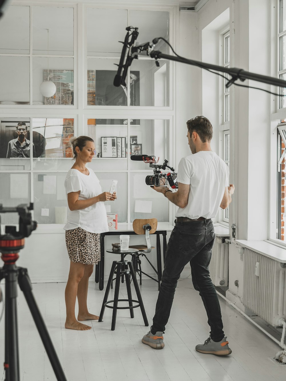 man and woman holding camera in front of camera