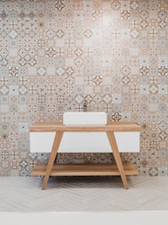 brown wooden table beside white and black wall