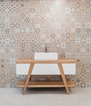 brown wooden table beside white and black wall