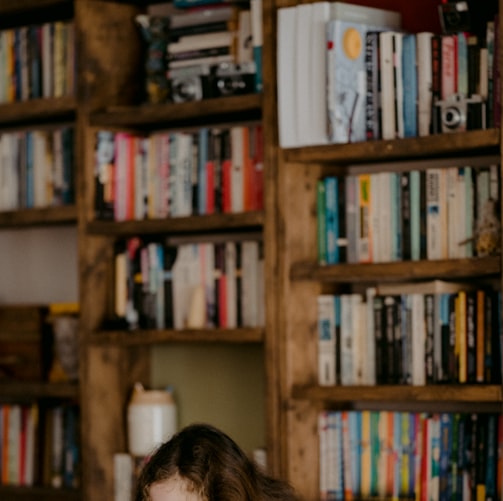 woman in black shirt sitting on chair