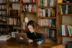 woman in black long sleeve shirt using macbook