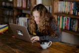 woman in black jacket using macbook pro
