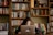 A young adult studying on a laptop in a cozy home environment.