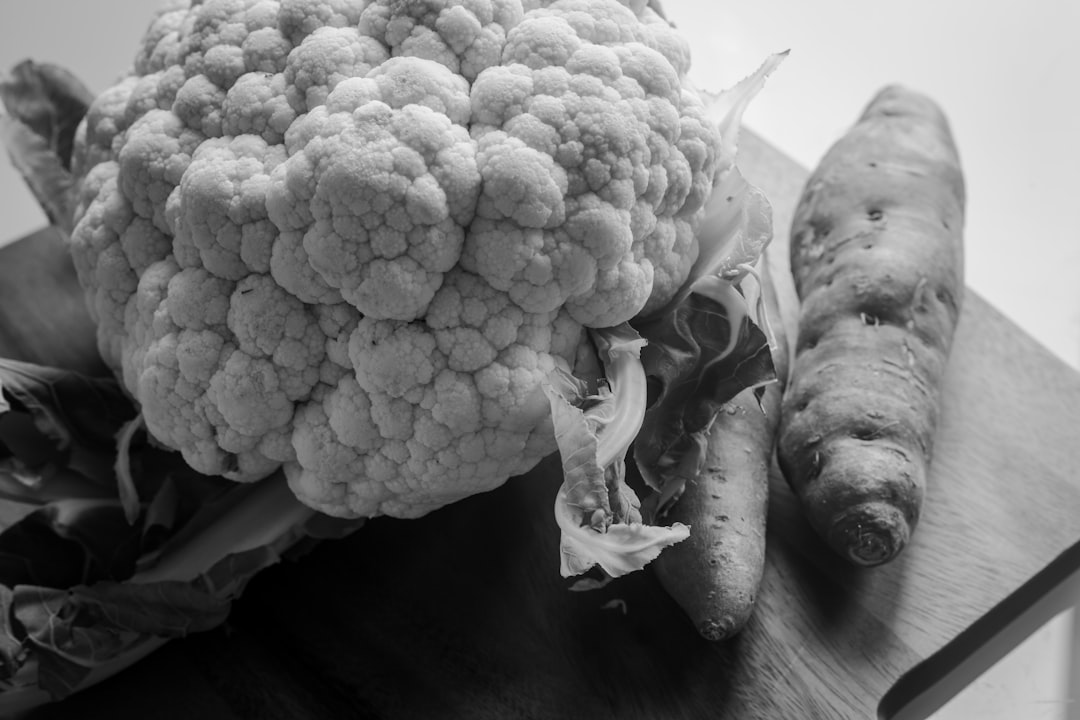 grayscale photo of cauliflower on black textile