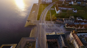 A sweeping drone shot over Lagos' bustling waterfront at golden hour.