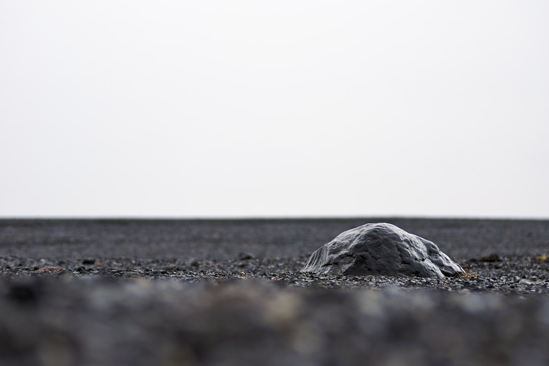 gray rock on black sand during daytime