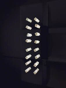 Close-up of sleek LED profiles and luminaires arranged on a minimalist white surface.