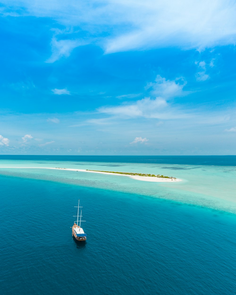 Barca bianca e blu sul mare sotto il cielo blu durante il giorno