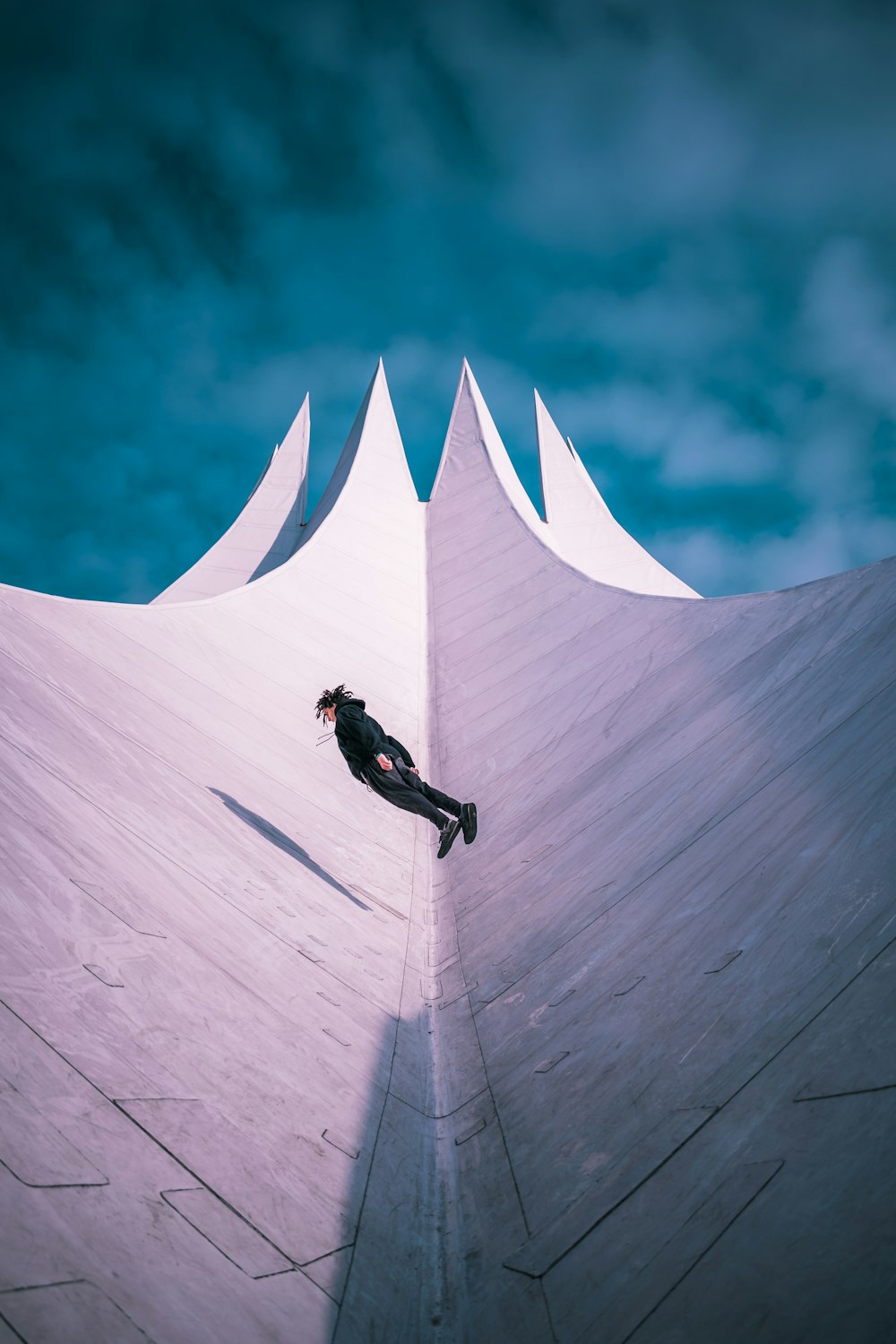 man in black jacket and black pants riding white surfboard