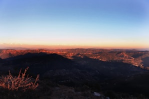 A panoramic view of the rugged Balochistan landscape at sunset.