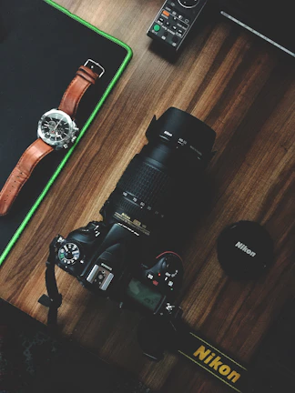 Close-up of a Nikon Z8 camera resting on a wooden table with travel maps.