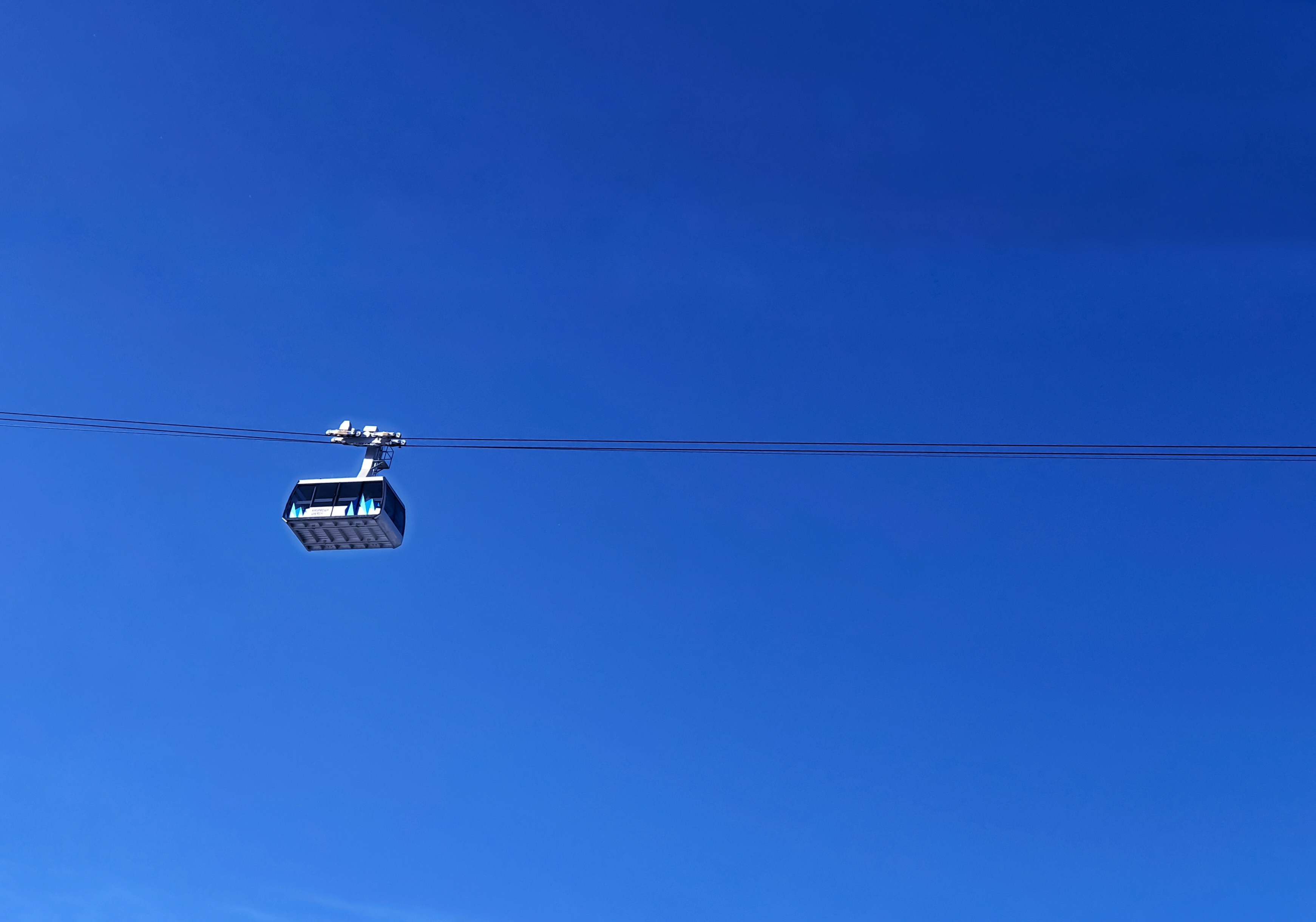 Black cable car under blue sky during daytime photo Free Blue Image on Unsplash